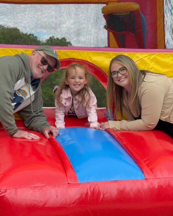 Family enjoying inflatable bounce house at birthday party